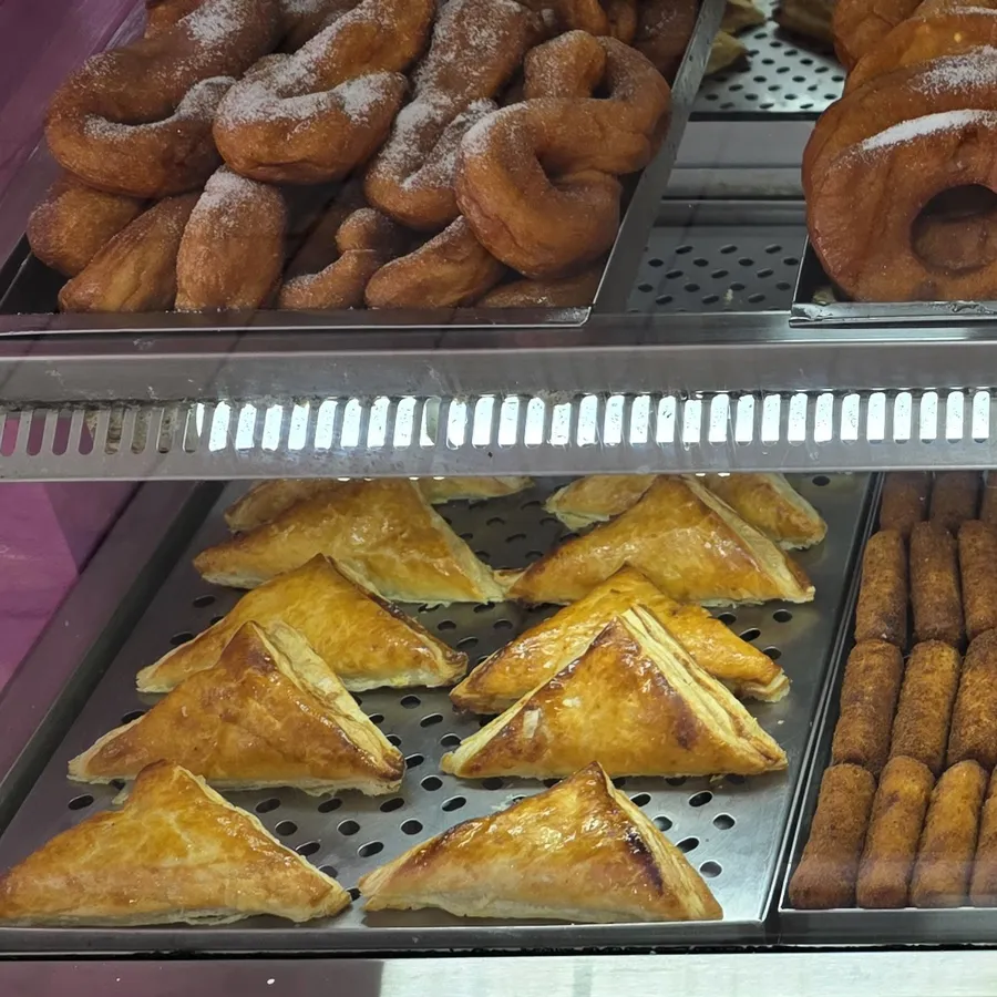 Bandejas de pastelitos de hojaldre reci&eacute;n horneados dentro de la vitrina caliente