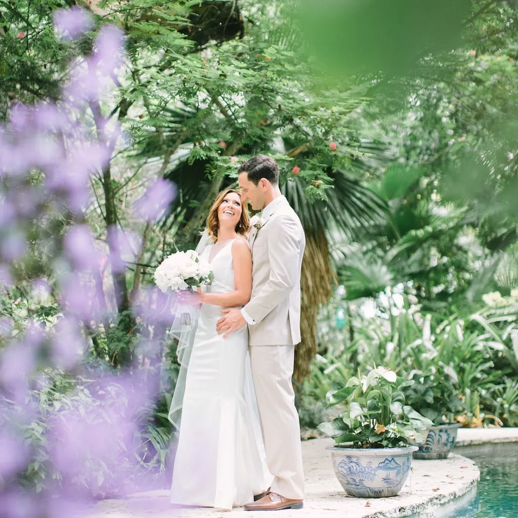 Couple embracing in a garden of flowering purple blooms
