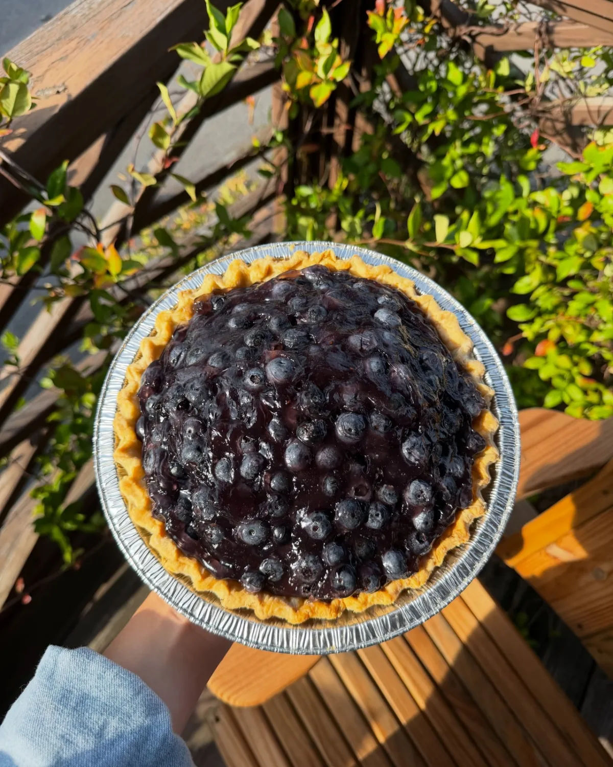 A blueberry pie piled high with whole berries