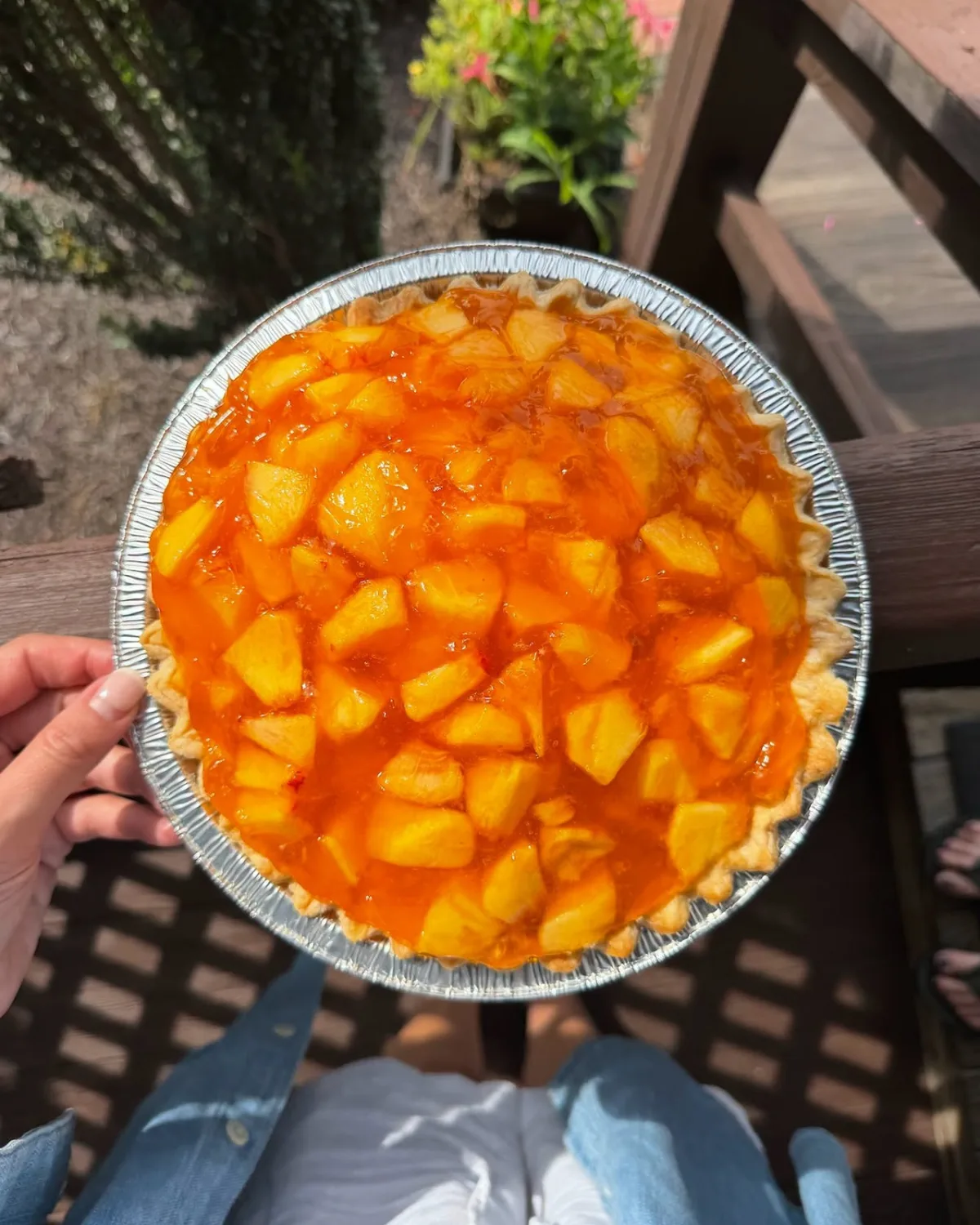 A peach pie filled with fresh cut peaches