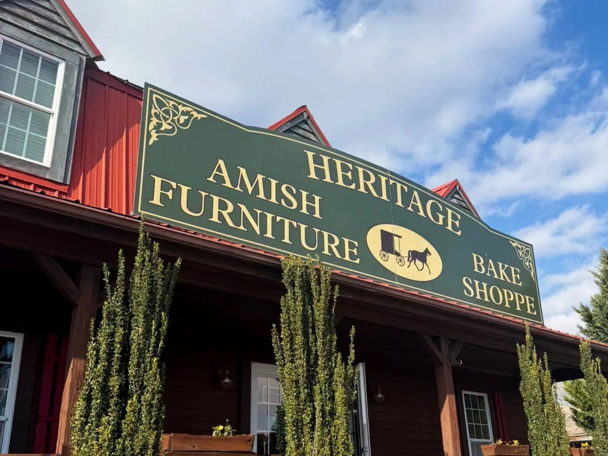 The Heritage Amish Furniture and Bake Shoppe building on Dam Neck Road, with its green sign and front porch