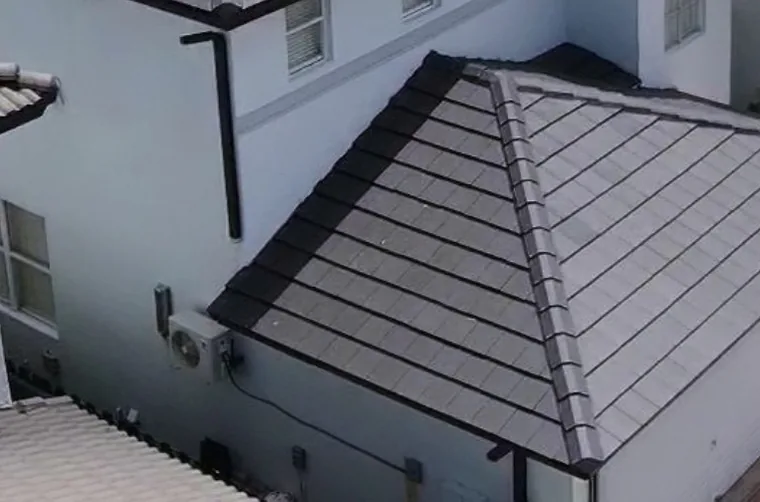House with a newly installed dark gray tile roof, seen from above.